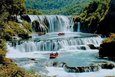 a group of people rafting down a waterfall at Apartman EMA in Kulen Vakuf