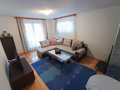a living room with a couch and a coffee table at Apartman EMA in Kulen Vakuf