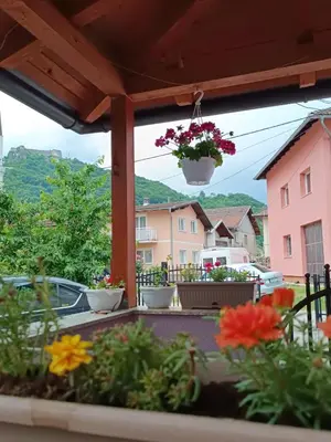 a balcony with flowers and a view at Apartman EMA in Kulen Vakuf