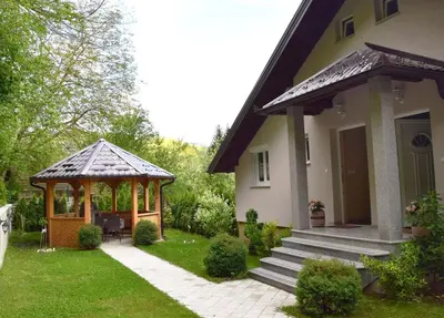 a house with a gazebo in the yard at Apartments A&D in Bihać