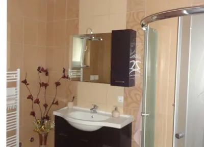 a bathroom with a sink and a mirror at Apartments A&D in Bihać