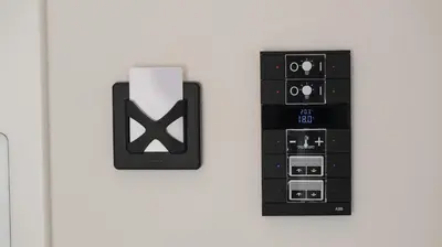 a black control panel on a white wall at Belvedere rooms A&E in Velika Kladuša