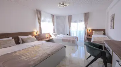 a hotel room with two beds and a desk at Belvedere rooms A&E in Velika Kladuša