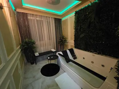 a bathroom with a bath tub in a room at Apartman Spa kristal in Banja Luka