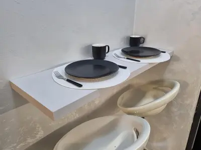 two toilets with plates and utensils on a shelf at Apartman Spa kristal in Banja Luka