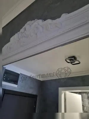 a white ceiling with a sign above a mirror at Apartman Spa kristal in Banja Luka