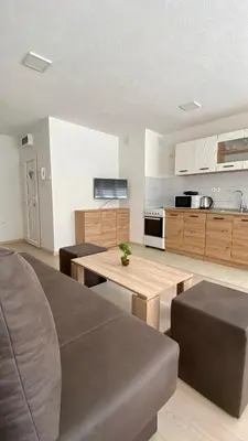 a living room with a table and a kitchen at Apartment Diletta in Banja Luka