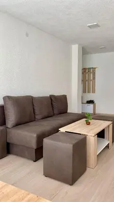 a living room with a brown couch and a coffee table at Apartment Diletta in Banja Luka