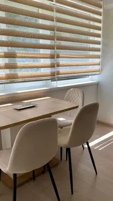a table and two chairs in front of a window at Apartment Diletta in Banja Luka