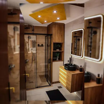 a bathroom with a shower and a sink and a mirror at Tesla Apartman Prnjavor in Prnjavor
