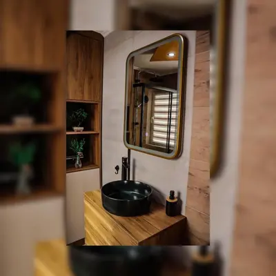 a bathroom with a black sink and a mirror at Tesla Apartman Prnjavor in Prnjavor