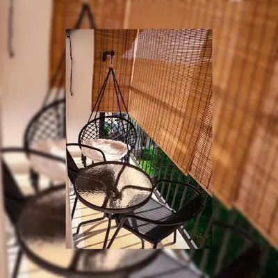 a reflection of four chairs in a bird cage at Tesla Apartman Prnjavor in Prnjavor