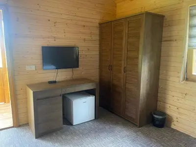 a room with a desk with a television and a cabinet at Etno zona Oaza mira in Donji Vakuf