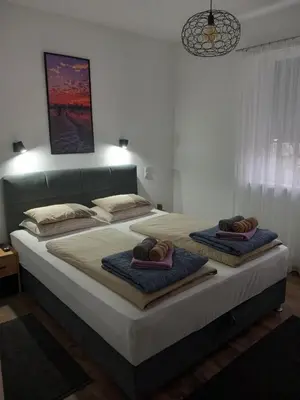 a bedroom with two beds with towels on them at Apartman DEA in Bihać