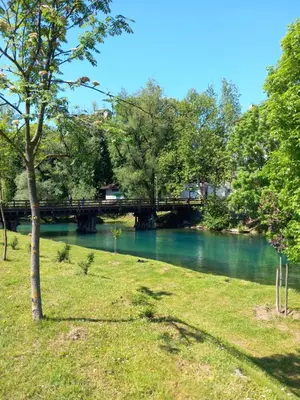 a view of a river with a bridge in the background at Apartman DEA in Bihać