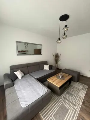 a living room with a couch and a table at Apartman DEA in Bihać