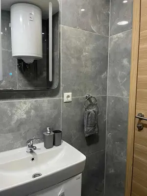 a bathroom with a sink and a mirror at Apartman DEA in Bihać