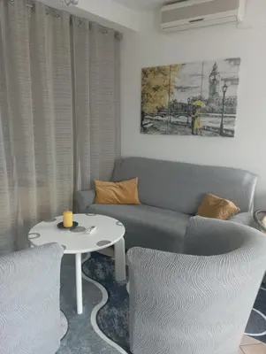 a living room with a couch and a table at Studio apartman Nejra in Bihać