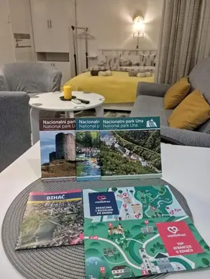 a table with brochures on top of a table at Studio apartman Nejra in Bihać