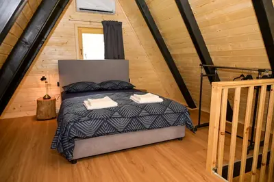 a bedroom with a bed in a tiny house at Cottage NIKA in Jajce