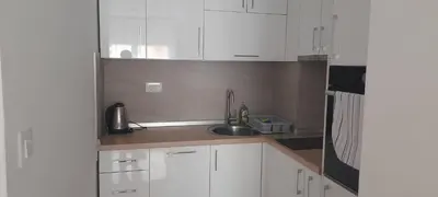 a kitchen with white cabinets and a sink at Nela Bl in Banja Luka