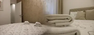 a pile of towels sitting on top of a bed at Nela Bl in Banja Luka