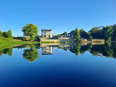 a house on a bridge over a lake at Vila Didan-apartmani in Bihać