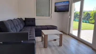 a living room with a couch and a table at Vila Didan-apartmani in Bihać