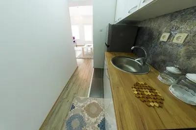 a bathroom with a sink and a counter with fruit on it at Apartman SUMI in Bihać