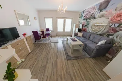 a living room with a couch and a tv at Apartman SUMI in Bihać
