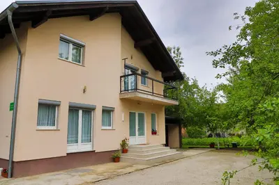 a house with a balcony and a porch at Apartman SUMI in Bihać