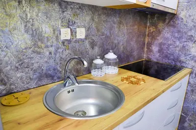 a kitchen counter with a sink in a kitchen at Apartman SUMI in Bihać