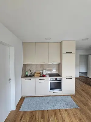 a kitchen with white cabinets and a sink at Apartmani gradina Tuzla in Tuzla