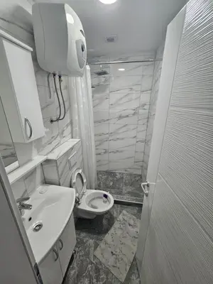 a bathroom with a toilet and a sink and a shower at Apartmani gradina Tuzla in Tuzla