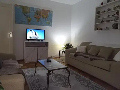 a living room with a couch and a tv at Apartment KARO in Visoko