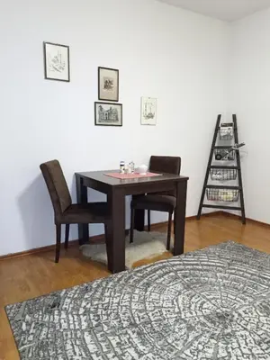 a room with a table and two chairs and a ladder at Apartment KARO in Visoko
