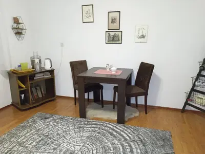 a dining room table and chairs in a room at Apartment KARO in Visoko