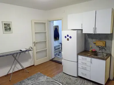 a kitchen with a white refrigerator and a sink at Apartment KARO in Visoko
