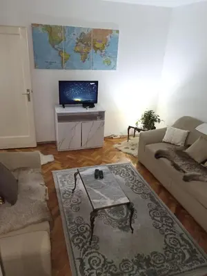 a living room with a couch and a tv at Apartment KARO in Visoko