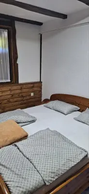 two beds in a room with a window at Holiday house 