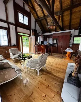 a large living room with wooden floors and a wooden ceiling at Holiday house 
