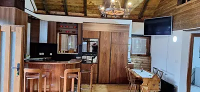 a kitchen with a bar with a table and chairs at Holiday house 
