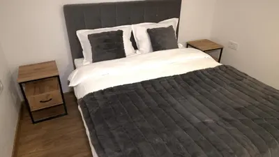 a large bed in a bedroom with two night stands at Kuća za odmor GAVRIĆ in Mrkonjić Grad