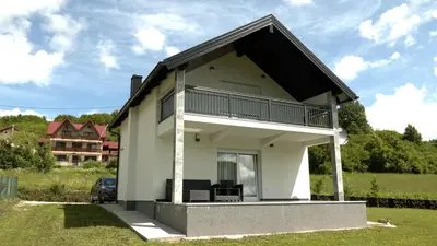 a white house with a black roof at Kuća za odmor GAVRIĆ in Mrkonjić Grad