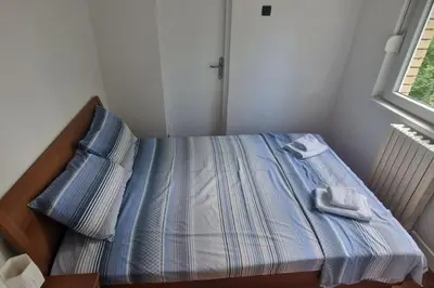 a bed in a room with two towels on it at Apartman Nataša BL 2 in Banja Luka