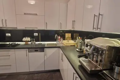 a kitchen with white cabinets and a counter top at Apartman Nataša BL 2 in Banja Luka