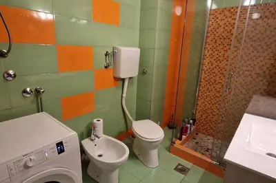 a bathroom with a toilet and a sink and a shower at Apartman Nataša BL 2 in Banja Luka