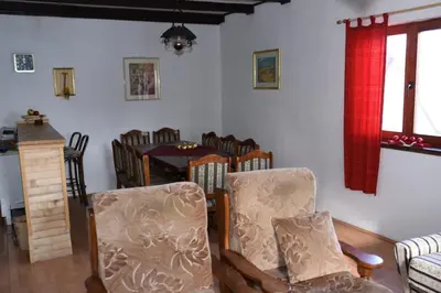 a living room with a dining room table and chairs at Brano in Kupres