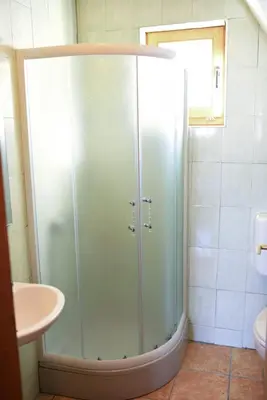 a shower with a glass door in a bathroom at Brano in Kupres