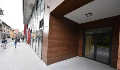 a building on a street with people walking on the sidewalk at Central Luxe in Banja Luka